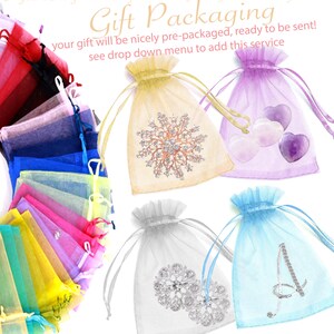 May include: A selection of organza gift bags in a variety of colours, including yellow, purple, silver, and blue. Some bags feature decorative elements. The text "Gift Packaging" is displayed on the image.