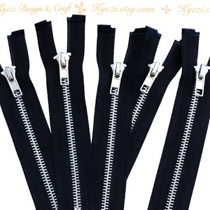 May include: Six black zipper closures with silver teeth. The zippers are open and laid out in a row.