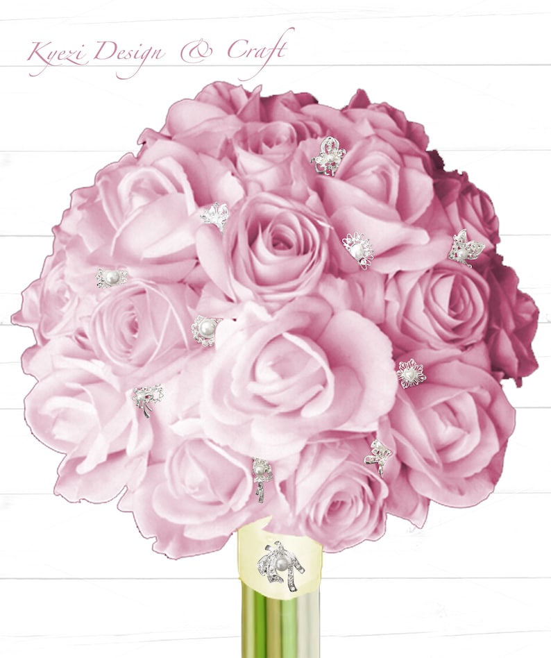 May include: A bouquet of light pink roses adorned with silver-colored embellishments. The bouquet is tied with a light yellow ribbon and rests in a green and yellow vase. The text "Kyezi Design & Craft" is at the top.