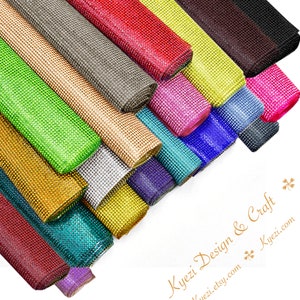 May include: A variety of colors of rhinestone trim, arranged in a fan shape. The trim is made of small, sparkling rhinestones that are set in a clear, flexible backing. The trim is available in a variety of colors, including gold, silver, red, blue, green, and pink.
