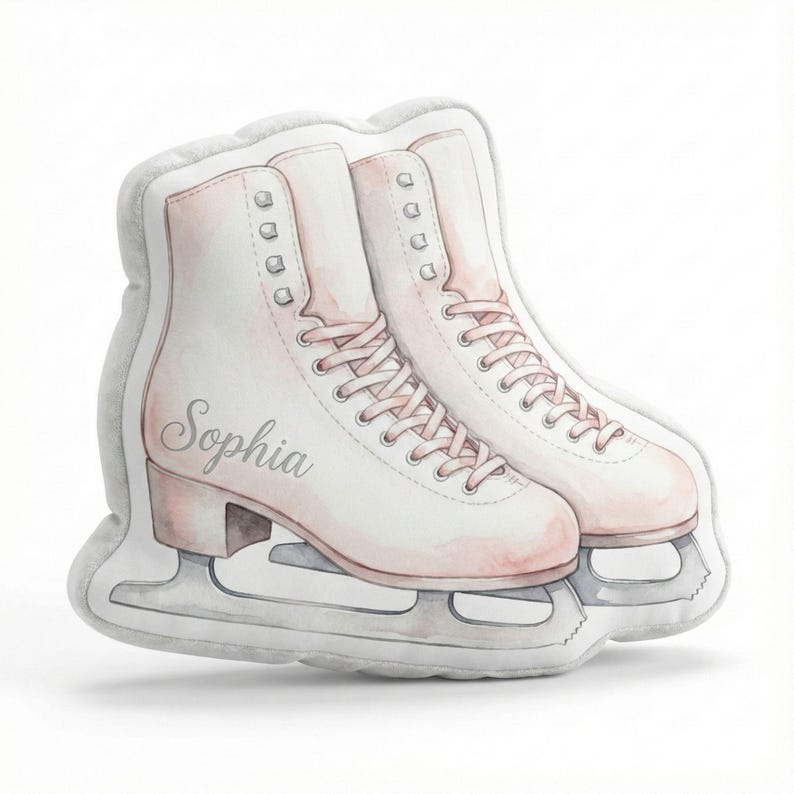 May include: A pair of decorative ice skates in a soft, watercolor style. The skates are primarily white with pale pink accents, including the laces and heel. The name "Sophia" is written on one skate. The blades are silver.