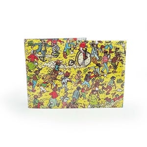 May include: A yellow wallet with a vibrant illustration of a running crowd. The design showcases numerous figures in diverse attire, set against a dotted backdrop. The rectangular wallet is likely made from a robust material.