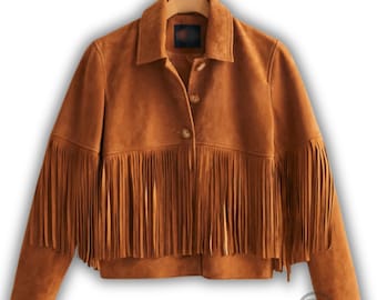 May include: A brown suede jacket with fringe detailing on the sleeves and hem. The jacket has a collared neckline, button-up front, and a classic western style. The jacket is hanging from a wooden hanger.