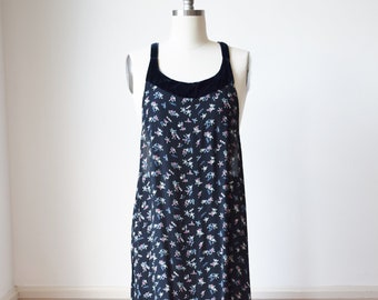 May include: A black maxi dress with a floral print and a velvet trim around the neckline.