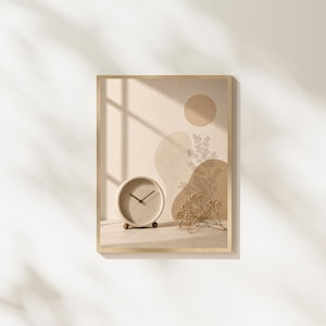 May include: A framed wall art print featuring a beige background with abstract tan shapes, a circular sun-like form, and a small round clock placed in the foreground next to a delicate sprig of dried baby's breath flowers with soft shadows.