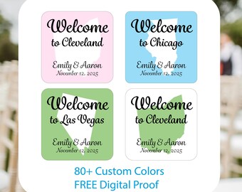 May include: Four square stickers with the words "Welcome" and the names "Emily & Aaron" with a date. Each sticker has a different city name and a map outline of the city. The background colors are pink, blue, and green.
