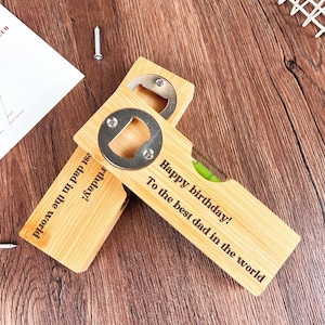 May include: Two wooden bottle openers with a built-in level and a metal bottle cap opener. One opener reads "Happy birthday! To the best dad in the world." The other reads "est dad in the world birthday!"