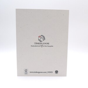 May include: A rectangular off-white card featuring a small circular logo with a goose and a heart. Below the logo, the text reads TINKER GOOSE Handcrafted with a heart symbol in New Hampshire. The bottom includes a website URL and copyright 2025.