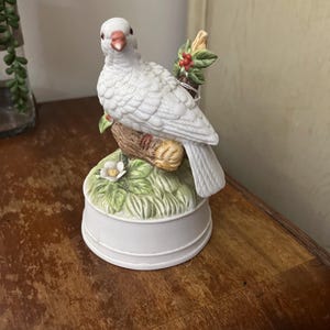 a Royal Crown Kimco Porcelain Bisque White Dove Music Box