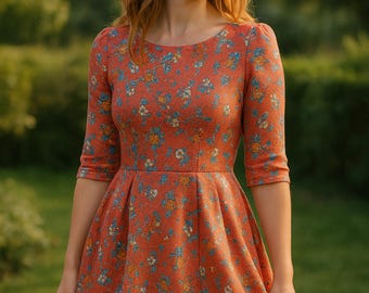 May include: A rust-colored dress with a floral pattern featuring blue, yellow, and white flowers. The dress has a scoop neckline, three-quarter sleeves, and a flared skirt. The dress is made of a textured fabric.