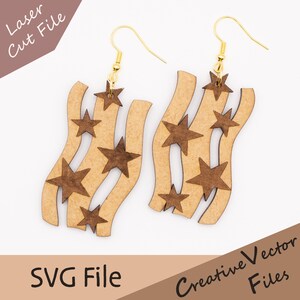 May include: Wooden earrings with a wavy design and star cutouts. The earrings have gold-colored hooks and are made of light brown wood with dark brown stars. The text "Laser Cut File" and "SVG File" are visible.