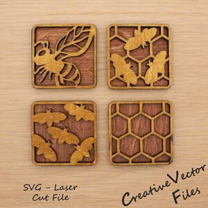May include: Four square wooden coasters featuring laser-cut designs. One shows a large bee, another shows two bees on a honeycomb grid, the third shows four small bees, and the fourth shows a plain honeycomb pattern. Text reads SVG - Laser Cut File.