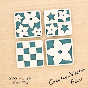 May include: Four square coasters with white floral and geometric designs. Each coaster has a teal background. The text "SVG - Laser Cut File" and "Creative Vector Files" are visible.