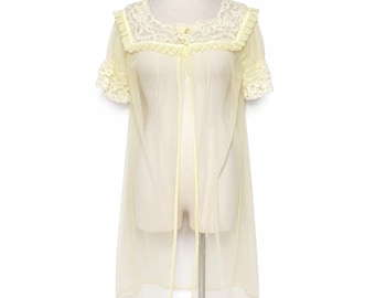 May include: A pale yellow sheer robe featuring short sleeves with ruffled lace trim, a square neckline adorned with intricate floral lace, and a central decorative fabric flower. The garment has an open front design with a light yellow trim.