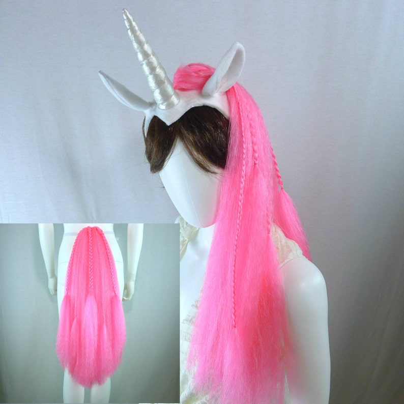 May include: White unicorn headband with a pink mane and tail. The headband has a silver horn and white ears. The mane and tail are made of long, flowing pink yarn.