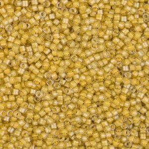 May include: A close-up shot of numerous small, cylindrical beads. The beads are predominantly yellow with a translucent, white core. The beads are densely packed, forming a textured surface. Ideal for jewellery making and various craft projects.