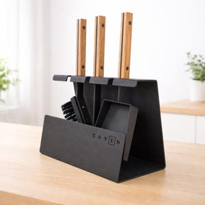 May include: A black fireplace tool set with three tools and a stand. The tools have wooden handles and are displayed in a black metal holder. The word "SAVEN" is printed on the front of the stand.