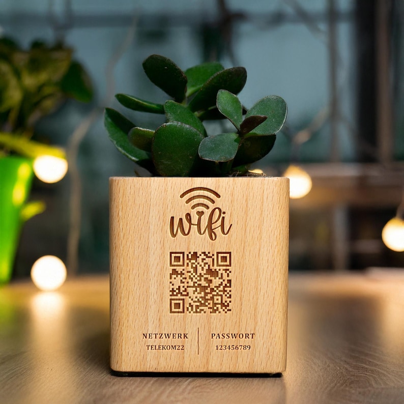 May include: A wooden planter with a succulent plant. The planter has the word "wifi" and a QR code etched on the front. Below the QR code are the words "NETZWERK TELEKOM22" and "PASSWORT 123456789".