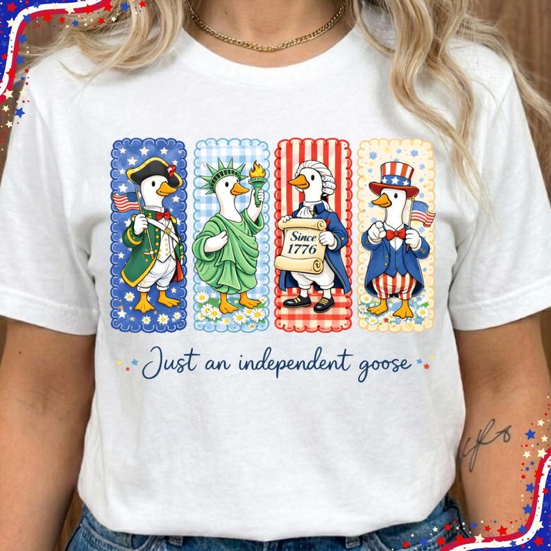 May include: White t-shirt featuring a patriotic design with four cartoon geese dressed in historical and symbolic American attire. The geese are in decorative frames, and the text "Just an independent goose" is below.