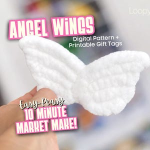 May include: A white crocheted angel wings ornament with text overlays reading ANGEL WINGS, Digital Pattern + Printable Gift Tags, Easy-Peasy 10 Minute Market Make!, and LoopywithJulie. The wings feature a textured, soft yarn construction.