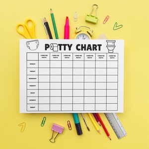 May include: A white "Potty Chart" with a diaper and toilet graphic, surrounded by school supplies on a yellow background. The chart has spaces for each day of the week and spaces to mark potty use. Includes pencils, scissors, and a small clock.