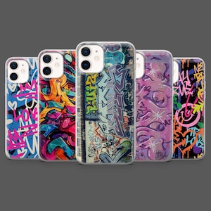 May include: A collection of five phone cases with graffiti art designs. Each case features a different vibrant color scheme, including blue, orange, purple, and black. The graffiti art includes tags, hearts, and abstract shapes, creating a bold and urban aesthetic.