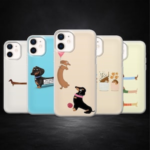 May include: A collection of five phone cases featuring dachshund dog illustrations. The cases showcase various designs, including a dog with a balloon, a dog with a sign that says "I'M HAVING A LONG DAY", and dogs in flower pots. The cases have a clear, protective design.