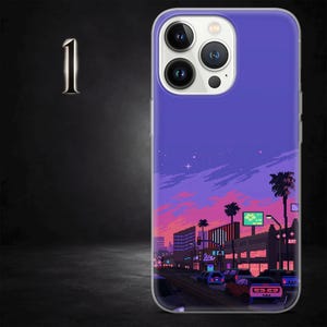 May include: A phone case with a pixel art design of a city at sunset, with palm trees and cars. The case has a purple sky with pink and orange colours, and a detailed cityscape.