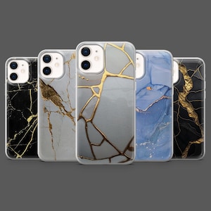 May include: Five phone cases with marble designs. The cases feature a variety of colors, including black, white, gray, and blue, with gold veining. The cases are made of a clear material and have a glossy finish.
