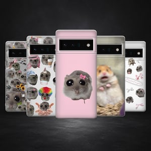 May include: A collection of phone cases with various designs. The cases feature images of hamsters, some with accessories like bows and hats. The cases are in shades of pink, white, and gray, with a black background.
