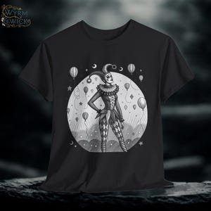 May include: Black t-shirt with a monochrome illustration of a jester inside a circle, with balloons and stars. The jester is dressed in a harlequin costume and a ruffled collar. The shirt has the text "W.Y.R.M. & WICK" in the upper left corner.