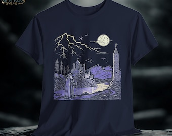 May include: Navy blue t-shirt featuring a detailed illustration of a wizard in a landscape with a castle, tower, and moon. The artwork is in shades of purple and white, with lightning in the background. The brand logo is in the upper left corner.