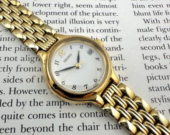 Reloj Seiko vintage pequeño para mujer, tono dorado, esfera blanca, estilo retro de los años 80, diseño clásico de Seiko, tamaño máximo de muñeca: 6,5".