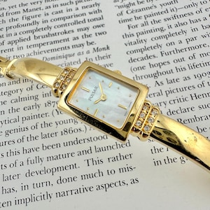Pulsar by Seiko Gold Tone Bangle Watch, Mother of Pearl Dial, Crystal Accents, Rectangular Case, Elegant Women’s Bracelet Timepiece