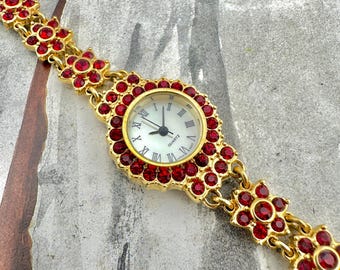 Vintage Gold Bracelet Watch with Red Rhinestones, Floral Design, Roman Numeral Dial, Elegant Statement Jewelry, Bold Retro Style