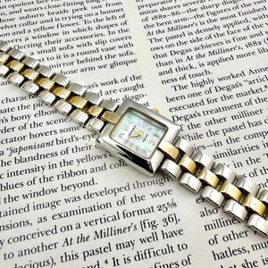 Klasyczny damski zegarek Milan, dwukolorowy, z tarczą z masy perłowej, prostokątną kopertą i bransoletą w odcieniu złota i srebra, sprawny, maksymalny obwód nadgarstka 6,7 cala