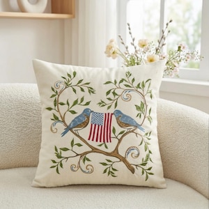 May include: A white ceramic mug with a black handle and the text "But First, Coffee" in a black, handwritten-style font. The mug is on a white surface.