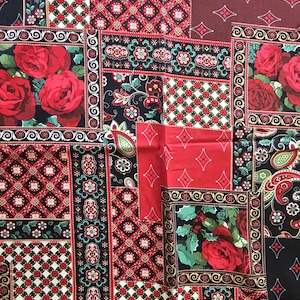 May include: A patchwork fabric featuring a variety of patterns and motifs. The design includes red roses, paisley, and geometric shapes in red, black, white, and green. The fabric is likely used for quilting or crafting.
