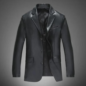 May include: A black leather blazer with a notched lapel, three-button closure, and two front pockets. The jacket has long sleeves and a tailored fit. The blazer is a classic style, suitable for various occasions.