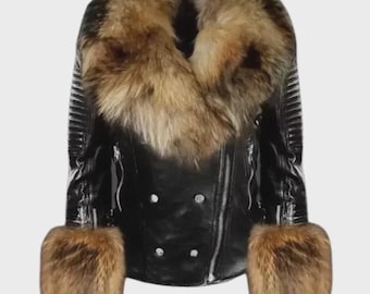 May include: A black leather jacket with a brown fur collar and cuffs. The jacket has a double-breasted design with silver buttons and a zipper closure. The fur appears to be a mix of brown and tan.