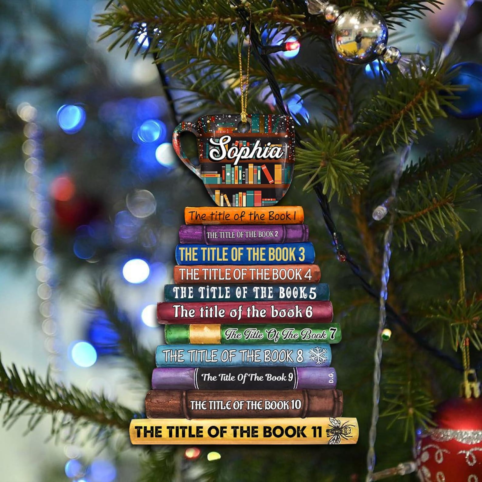 Christmas tree with colorful lights and a book-themed ornament. The ornament features a stack of books topped with a personalized mug reading.