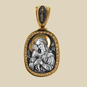 May include: An oval pendant in gold and silver, depicting a religious icon of a woman and child. The pendant has a gold border and bail, with a cross at the top. The icon is detailed with religious text.