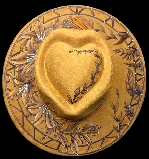 Hand-Burned Lillies on wide brim heart crown  hat, Khaki Brown vegan suede. Rhinestones attached by hand. Wearable Art