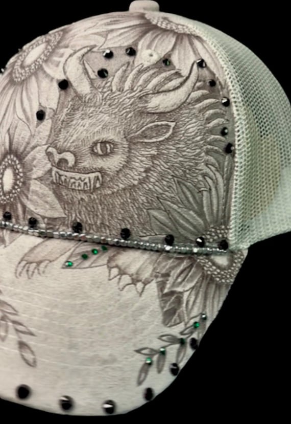 Hodag sparkle, hand-burned using a wood burner, grey Vegan (faux) suede, mesh ponytail back ball cap. Hand attached rhinestones.