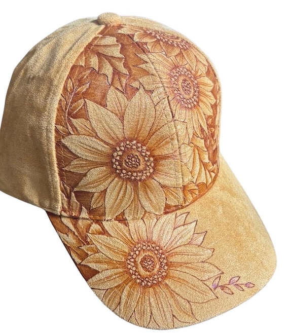 Hand-Burned sunflowers, using a hand held wood burner. Mustard Vegan Suede Ball Cap, with back slide size adjuster. One size fits most.