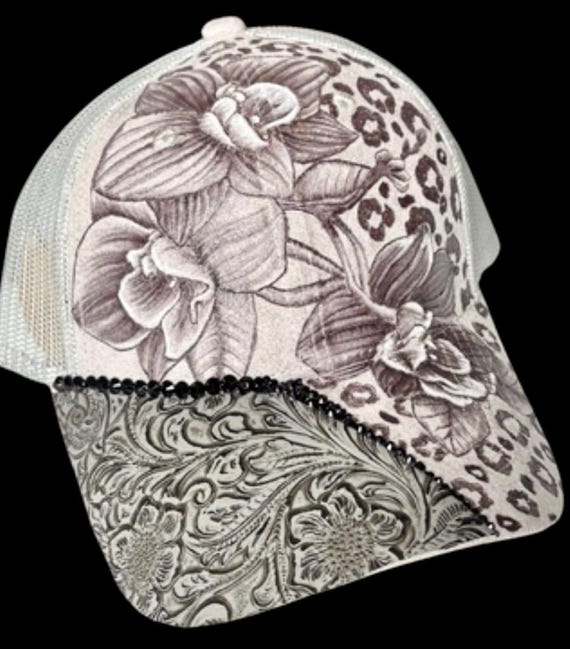 Cheetah print and orchids, hand-burned using a wood burning tool. Grey vegan (faux) suede, mesh ponytail back.