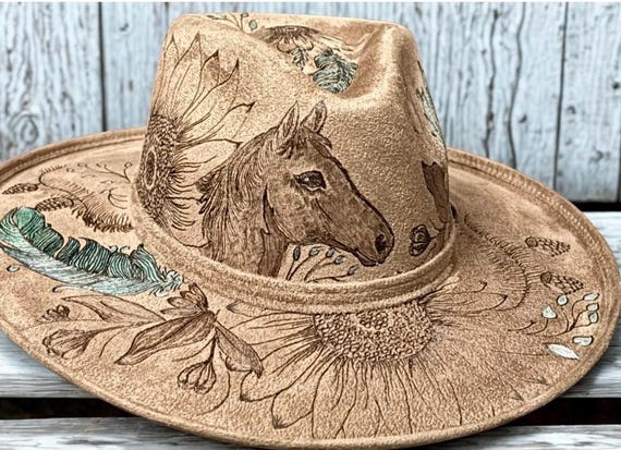 Horse and feathers hand burned hat, beautifully detailed on tan vegan suede using a wood burning tool. Teal and turquoise accents.