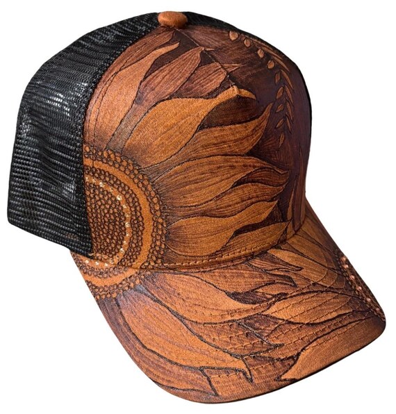 Free-hand, hand-burned sunflowers. Vegan (faux) suede trucker hat. Accent rhinestones, mesh slap back.