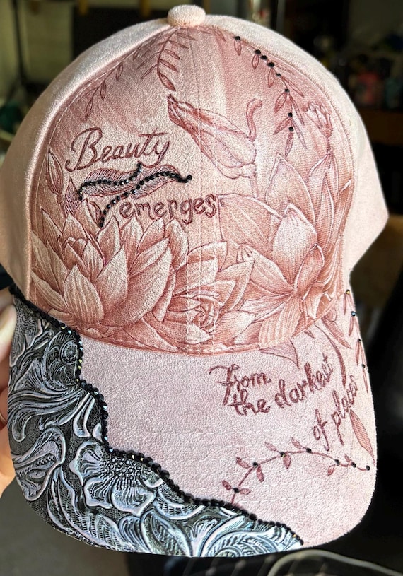 Beauty emerges, hand-burned lotus floral design, faux suede pink ball cap. Black rhinestones and matching faux leather.