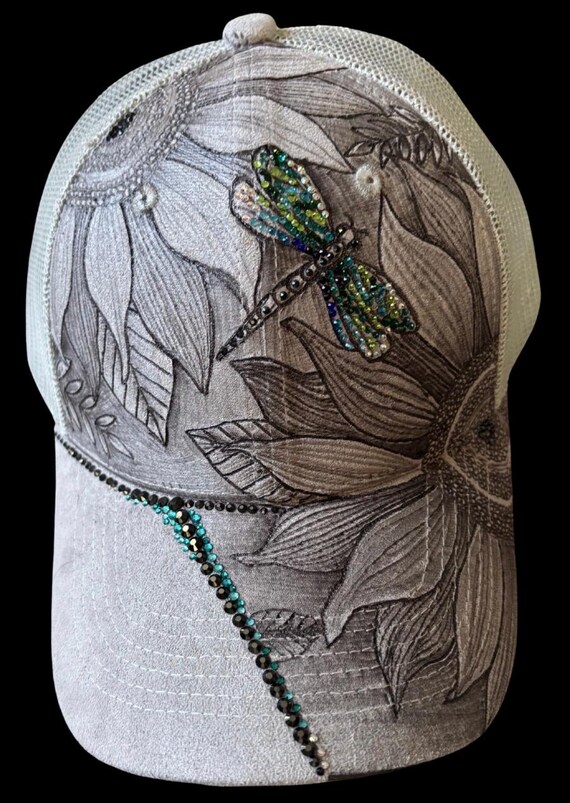 Flowers & dragonfly Free-hand, hand-burned Vegan (faux) suede ponytail ball cap. Shades of greens and blues rhinestones, mesh ponytail back.